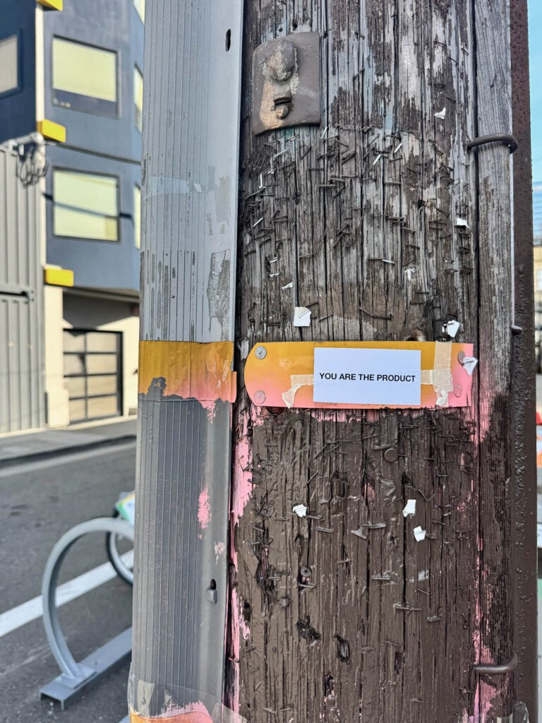 Control Text field test sticker reading “You Are The Product” installed on a utility pole in San Francisco.